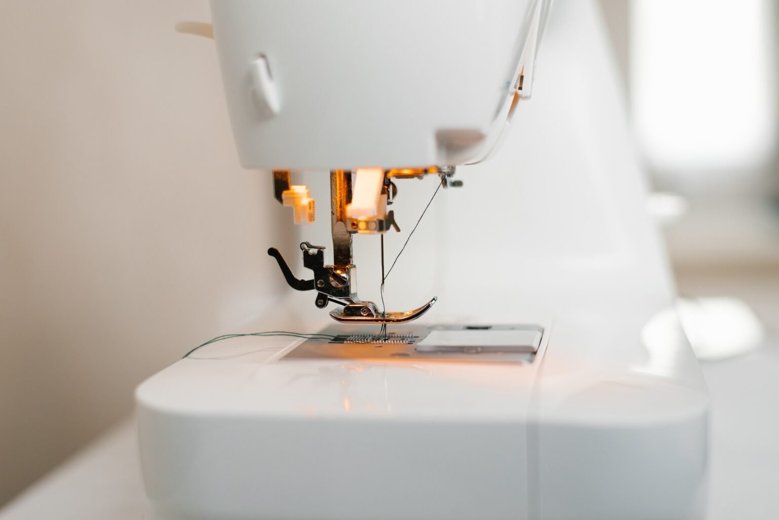 Close-up of a sewing machine with a needle and thread